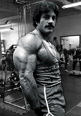 Mike Mentzer flexing his triceps - No B.S.: 4X for Mass-Building Success—Even Mentzer Would Confess