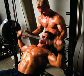 Steve spotting Jonathan on incline Smith machine presses - Ultimate Exercises and Mass Machines