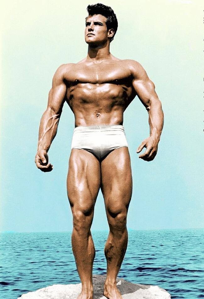 Steve Reeves on a rock at the beach (colorized photo)