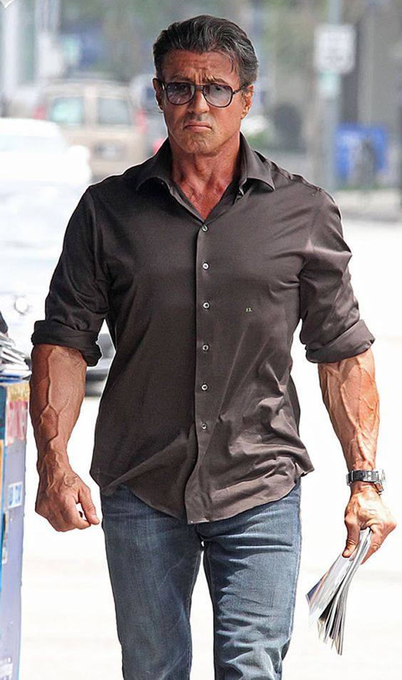 Sylvester Stallone walking with vascular forearms showing