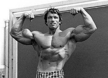 Arnold, double biceps in front of chalkboard
