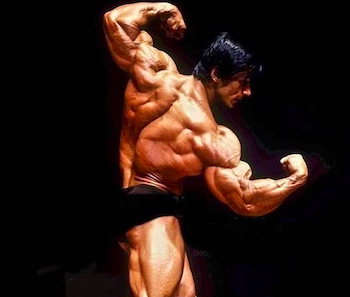 Danny Padilla in a twisting back pose on stage, cropped photo