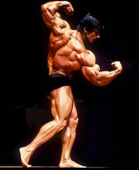 Danny Padilla in a twisting back pose on stage