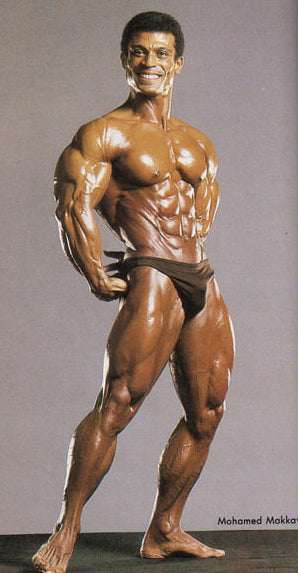 Mohamed Makkaway flexing his triceps in studio