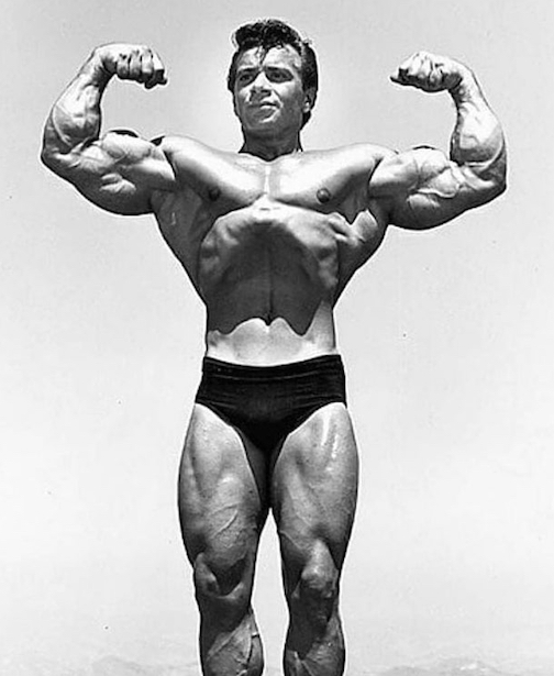 Freddy Ortiz flexing his arms, black and white