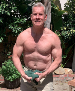 Image of Steve Holman in a most-muscular pose, looking smooth