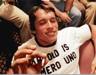 Arnold smoking a joint with his famous "Arnold is numero uno" t-shirt on