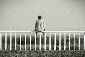 Man sitting on a fence contemplating