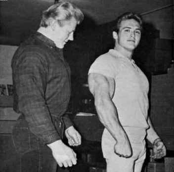 Dave Draper looking at Bill McArdle's triceps
