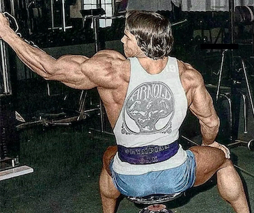 Arnold doing seated one-arm cable laterals - colorized photo