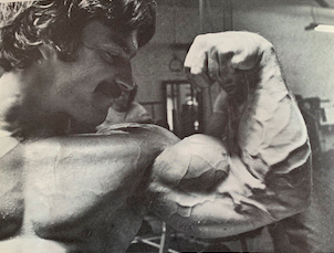 Mike Mentzer flexing his biceps
