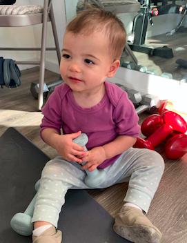 Baby Quinn holding dumbbell