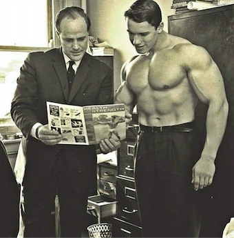 Arnold shirtless in an office