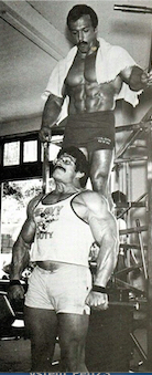 Mike Mentzer doing shrugs with Casey Viator on his shoulders
