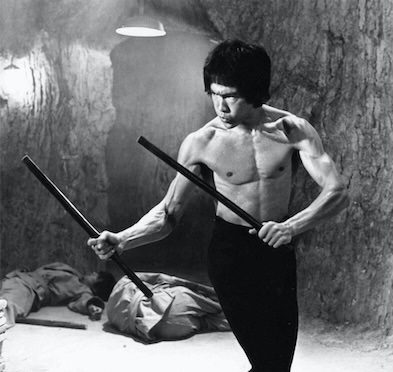 Bruce Lee holding Kali sticks in "Enter the Dragon"