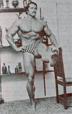 Arnold with a mustache doing kicks while holding a chair