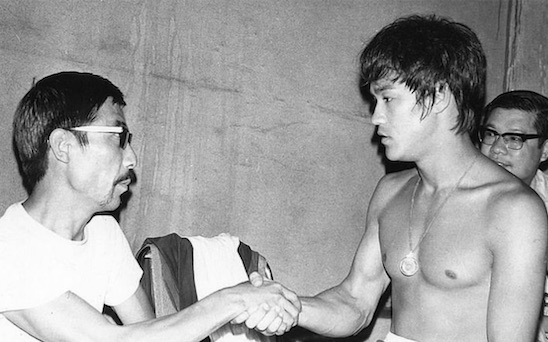 Bruce Lee shaking hands with Brocco