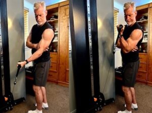 Steve Holman demonstrating one-arm supported cable curls from Old Man, Young Muscle 2
